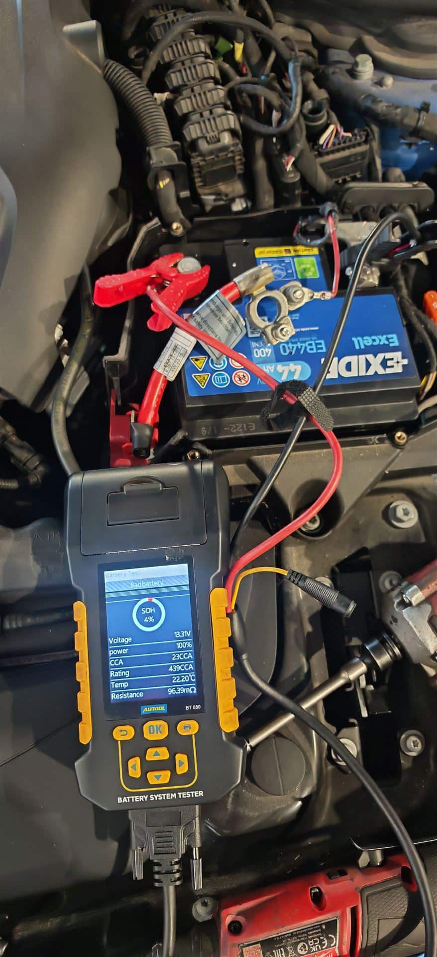 12V car battery testing using professional battery diagnostic equipment during vehicle inspection