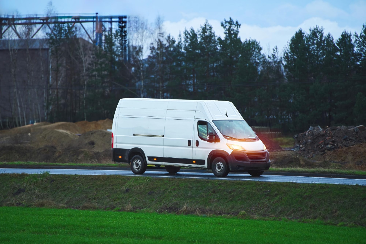 Electric commercial van driving on road for fleet vehicle solutions and business transport