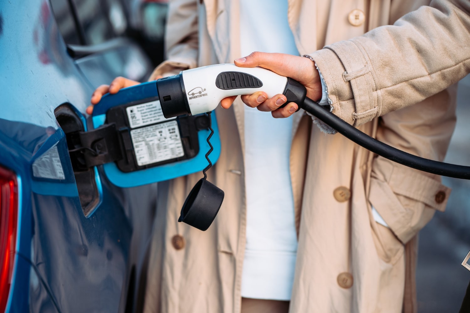 Electric vehicle charging cable connected to an EV charging port during vehicle charging