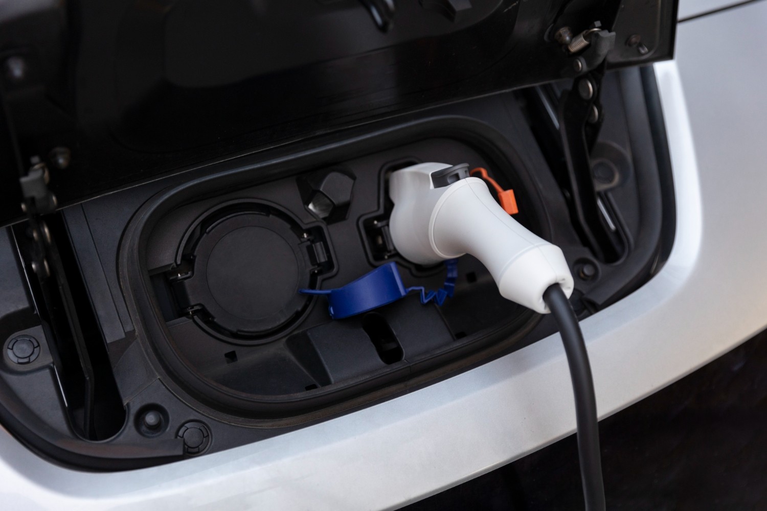 EV charging cable connected to an electric car's charging port.